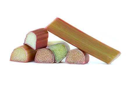 Group of rhubarb pieces in various shapes and sizes arranged in a scattered formation isolated on white backgroundの写真素材