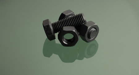 Black anodized bolt and nut placed on a reflective surface. Detailed close-up view fastenersの写真素材