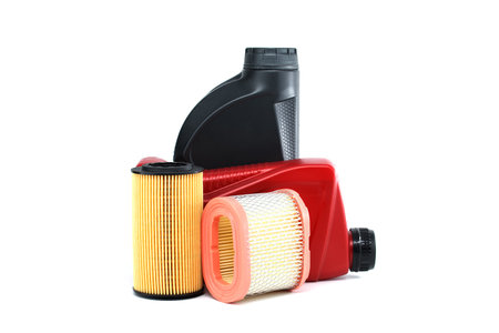 Vehicle engine oil filters elements and motor oil cans isolated on a white background. Containers, plastic storage or oil and filter replacing maintenanceの写真素材