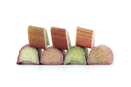 Rhubarb stalks of varying colors from pale green to deep red isolated on white background, illustrate a recipe for a rhubarb-based dishの写真素材