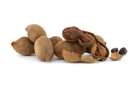 Tamarind fruits, whole and cracked open isolated on white background (Tamarindus indica)の写真素材