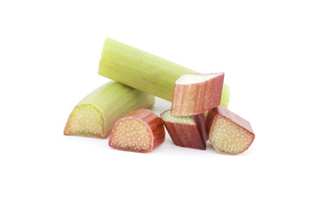 Group of rhubarb pieces in various shapes and sizes arranged in a scattered formation isolated on white backgroundの写真素材