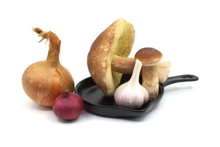 Process of food preparation with mushrooms and onions in the pan isolated on white backgroundの写真素材