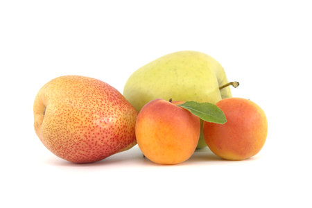 Whole ripe apricots, multicolored pear and apple isolated on a white background. Multivitamin and juicy rich fruitsの写真素材
