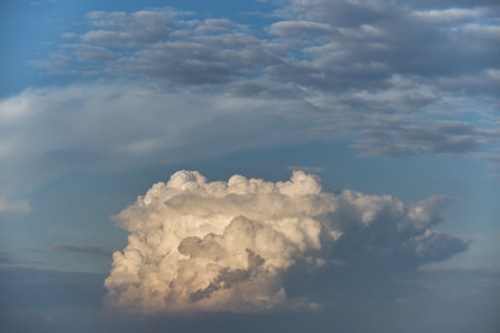 Fluffy cumulus clouds appearing soft and cotton-like with a broad spectrum of blue shades, highlighting the soothing and calming effects of a blue sky filled with cloudsの写真素材