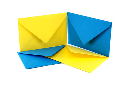 Four blue and yellow paper envelope arranged in a square formationの写真素材