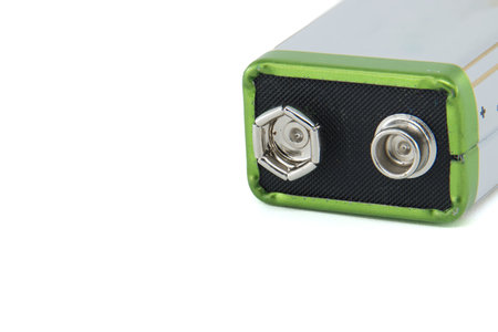 Close-up of a 9-volt battery with visible positive and negative terminals, highlighting its design...