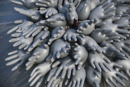 Inflated rubber gloves covered in water droplets forms an abstract artistic design. The image conveys creativity, uniqueness and texture through its intricate arrangement and reflective surfacesの写真素材