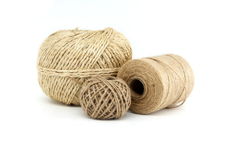 Close-up image of three natural twine ropes of different sizes on a white background, highlighting...