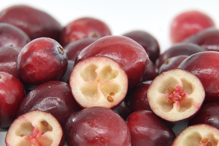 Close-up image showcasing fresh red cranberries highlighting their juicy texture and vibrant color....