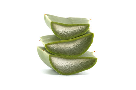 Stacked aloe vera slices against a clean, white background, showcasing the plant's inner gel.の写真素材