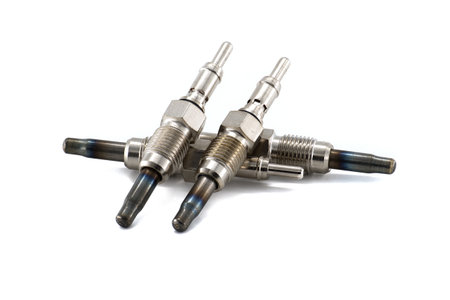 Detailed view of glow plugs designed for diesel engines, arranged on a white background, showcasing industrial and mechanical components.の写真素材