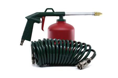 An air-powered spray gun and its accessories are presented on a white background, showing the tools ready for use.の写真素材