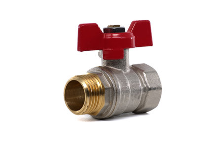 A close-up shot of a brass ball valve with a red handle on a white background, perfect for plumbing and industrial applications.の写真素材