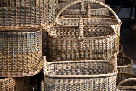A collection of handwoven baskets, showcasing different designs and sizes. The natural tones and...