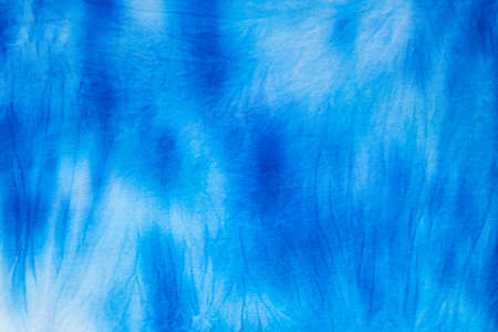 Blue abstract hand painted tie dye texture. Folk style design. Creative background for textile, fabric, wallpaper, wrapping paperの写真素材
