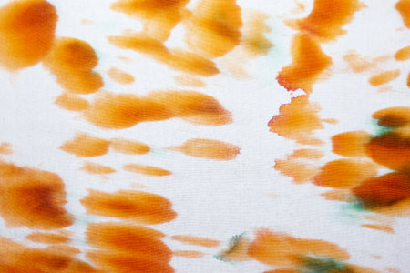 Orange and white abstract hand painted tie dye texture. Creative background for textile, fabric,...