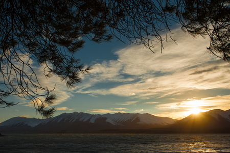 Mountain sunrise at lake tekapoの写真素材