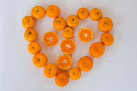Citrus fruits arranged in a heart shape の写真素材