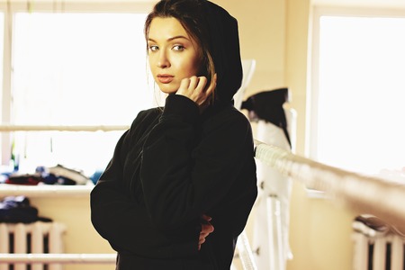 Portrait of beautiful boxing girl posing in the ring. Training at the gym. Sporty female doing boxing exercise.の写真素材