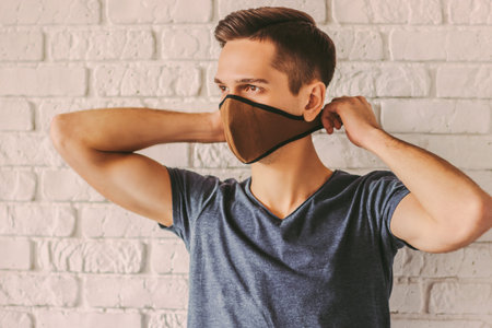 Hipster student wearing protective mask on face. Preventive measure against air pollution, nCov-19....