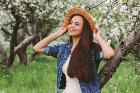 Portrait beautiful carefree hipster woman in stylish straw hat and denim jacket relax and have fun...