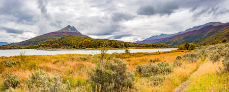 Beautiful landscape of lenga forest, mountains and lagoon at Tierra del Fuego National Park, Patagonia, summer timeの写真素材