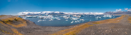 Panoramic view of Glacier Lagoon with icebergs and hikers, Jokulsarlon, Icelandの写真素材