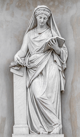 Ancient statue of sensual Italian Renaissance Era woman reading a book, Potsdam, Germanyの写真素材