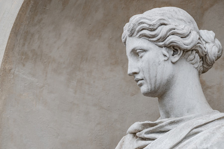 Ancient statue of sensual Italian renaissance era woman with long neck and curly hairs, Potsdam, Germanyの写真素材