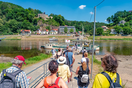 Ferry service with modern catamaran at Bastei sandstone pillars near Kurort Rathen village in the national park Saxon Switzerland by Dresden and Elbe river, Saxony, Germanyのeditorial素材
