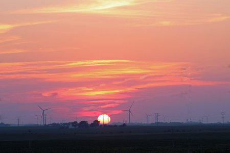 Sunset sky with wind turbines on the horizon