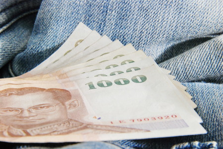 jeans with money on topの写真素材