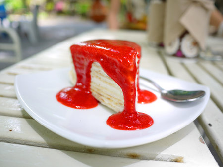 crepe cake and strawberry blueberry sauce