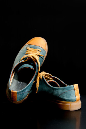 gray leather basketball shoe sneaker, isolated on blackの写真素材