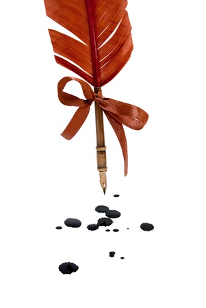 Feather quill and inkwell isolated on white. Ink blots on surface.の写真素材