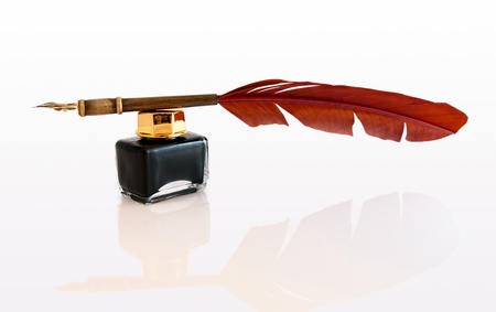 Feather quill and inkwell isolated on white.の写真素材