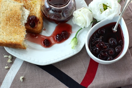Sweet cherry jam, toast and white flowersの写真素材