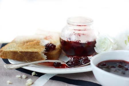 Sweet cherry jam, toast and white flowersの写真素材