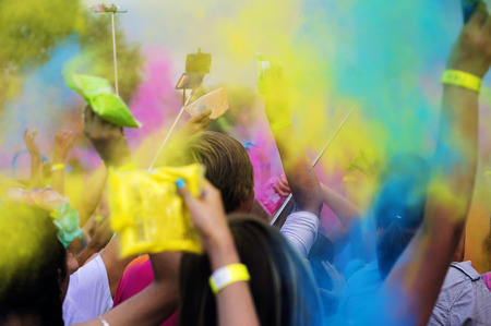Holi festival color explosion, hands with colorful powder sacksの写真素材