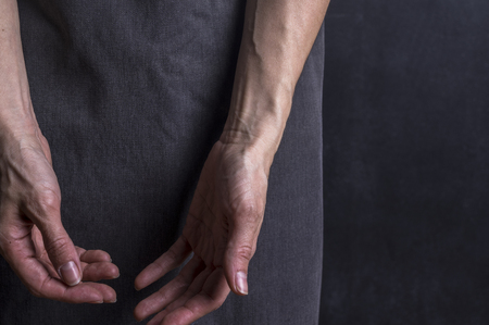 Womans hands with blood veins. Emotional gesture. Studio photographyの写真素材