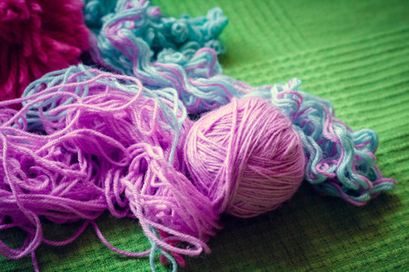 Wool threads on green backgroundの写真素材