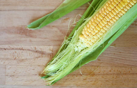 corn ear on wooden backgroundの写真素材