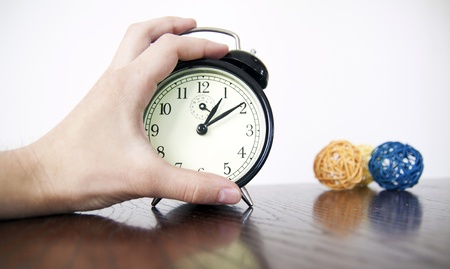 alarm clock detail with handの写真素材