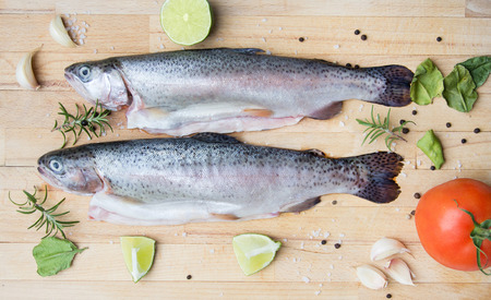rainbow trouts on wooden cutting boardの写真素材