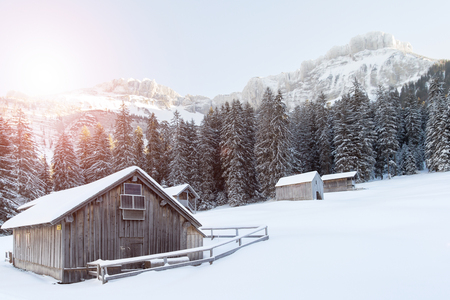 wooden house in snow covered mountainsの写真素材