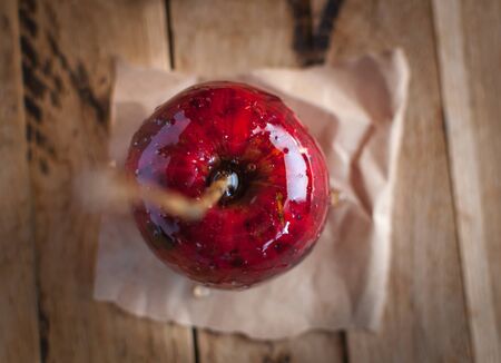 Close-up of candy apple on wooden background, top viewの写真素材