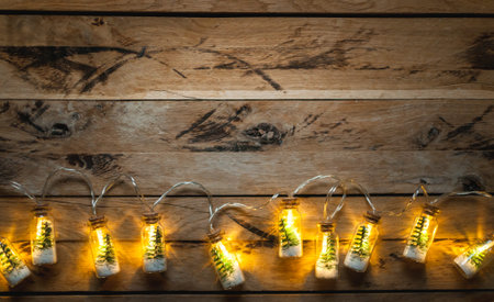 Christmas lights on wooden background. Top view, copy space