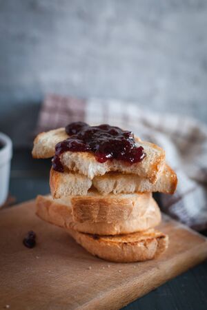 Close-up of toasted slices of bread with homemade strawberry jamの写真素材