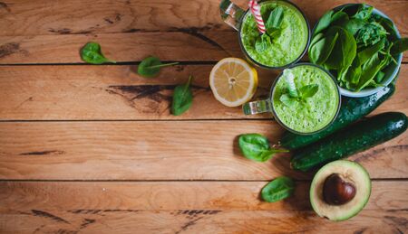 Close-up of green smoothie in a glass with fresh mint and ingredients, top view, copy space, text spaceの写真素材